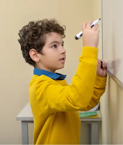 Student writing on whiteboard