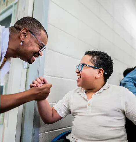 Student and teacher giving each other a handshake