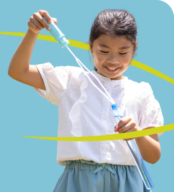 Student playing with bubble wand.