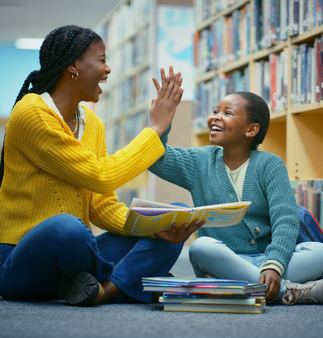 Educator and student reading together